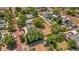 Aerial shot features the home, set on a quiet street with a spacious yard surrounded by mature trees at 504 7Th Sw Ave, Largo, FL 33770