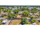 An aerial view shows a home with mature trees, a fenced yard, and neighborhood details at 504 7Th Sw Ave, Largo, FL 33770