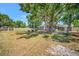 Spacious backyard with mature trees and seating areas; perfect for outdoor activities and relaxation at 504 7Th Sw Ave, Largo, FL 33770
