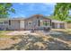 The home features a brick patio area with outdoor dining furniture, ideal for entertaining and relaxation at 504 7Th Sw Ave, Largo, FL 33770