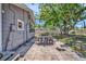 A home with a tiled patio provides a perfect outdoor dining setting and yard with mature shade trees at 504 7Th Sw Ave, Largo, FL 33770