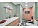 Stylish bathroom with a sleek vanity, decorative tile floor, and a modern glass-enclosed shower at 504 7Th Sw Ave, Largo, FL 33770