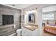 Bathroom with a vanity, a wood-look accent wall, and a connecting door to another bedroom at 504 7Th Sw Ave, Largo, FL 33770