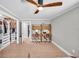 Open bedroom with a modern closet system, two desk areas, and wood-look floors, flooded with natural light at 504 7Th Sw Ave, Largo, FL 33770