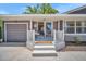 Cozy front porch with bench seating and a neutral color palette, perfect for relaxing outdoors at 504 7Th Sw Ave, Largo, FL 33770