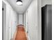 Bright hallway with a neutral palette, wood-look floors, and multiple closets for ample storage space at 504 7Th Sw Ave, Largo, FL 33770