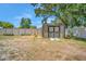 A backyard shed stands with a small garden enhancing the property's appeal, fenced for privacy at 504 7Th Sw Ave, Largo, FL 33770