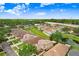 Aerial view of community, home and surroundings with pond at 5525 Turtle Crossing Loop, Tampa, FL 33625