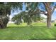 Lush green backyard with mature trees and pond at 5525 Turtle Crossing Loop, Tampa, FL 33625