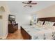 Cozy bedroom featuring hardwood floors, a ceiling fan and a comfy bed with decorative pillows at 5525 Turtle Crossing Loop, Tampa, FL 33625