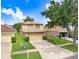 Charming two-story home features a well-maintained front yard, a two-car garage, and a welcoming entryway at 5525 Turtle Crossing Loop, Tampa, FL 33625