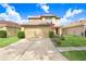 Charming two-story home features a well-maintained front yard, a two-car garage, and a welcoming entryway at 5525 Turtle Crossing Loop, Tampa, FL 33625