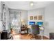 Bright home office features hardwood floors, white walls, and a ceiling fan for a comfortable workspace at 5525 Turtle Crossing Loop, Tampa, FL 33625