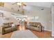 Open living area with hardwood floors, vaulted ceilings, comfortable furnishings, and views into the kitchen at 5525 Turtle Crossing Loop, Tampa, FL 33625
