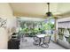 Screened patio with a ceiling fan, dining table set, and plants at 5525 Turtle Crossing Loop, Tampa, FL 33625