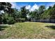Large backyard featuring mature trees, privacy fence, and expansive grassy area at 5642 9Th N Ave, St Petersburg, FL 33710