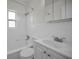 Bright bathroom featuring a white tiled shower and a modern white vanity with a large sink at 5642 9Th N Ave, St Petersburg, FL 33710