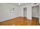 Bedroom features hardwood floors, a ceiling fan, and a closet, complemented by a window with blinds at 5642 9Th N Ave, St Petersburg, FL 33710