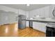 Updated kitchen with stainless steel appliances, white cabinets, and hardwood flooring throughout at 5642 9Th N Ave, St Petersburg, FL 33710