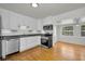 Updated kitchen featuring stainless steel appliances, white cabinetry and hardwood floors at 5642 9Th N Ave, St Petersburg, FL 33710