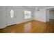 Spacious living room with hardwood floors, a front door, and a large bright window at 5642 9Th N Ave, St Petersburg, FL 33710