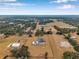 Expansive estate with a well-maintained home, solar panels, pool, and circular drive surrounded by lush trees at 602 Swilley Rd, Plant City, FL 33567