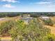 Stunning aerial perspective of a private estate featuring an impressive residence with detached garage and lush surroundings at 602 Swilley Rd, Plant City, FL 33567