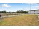 Large grassy backyard enclosed with wood and wire fencing at 602 Swilley Rd, Plant City, FL 33567