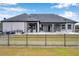 Home's backyard with a pool, patio, grass and fence at 602 Swilley Rd, Plant City, FL 33567