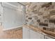 Contemporary bar area showcasing stone detailing and a glass wall partition at 602 Swilley Rd, Plant City, FL 33567