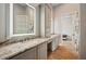 Bathroom with dual vanity, granite countertops, and wood floors at 602 Swilley Rd, Plant City, FL 33567