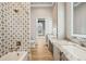 Bathroom with tile shower, granite counters, and wood look floors at 602 Swilley Rd, Plant City, FL 33567