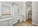 Elegant bathroom featuring double sinks, granite countertops, and custom cabinets at 602 Swilley Rd, Plant City, FL 33567