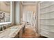 Bright bathroom with dual vanity, granite counters, and shelves at 602 Swilley Rd, Plant City, FL 33567