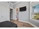 Bedroom showcasing wood floors, a TV, and an open door to a bathroom at 602 Swilley Rd, Plant City, FL 33567