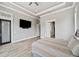 A bedroom with a tray ceiling, tv on wall, wood-look floors, and plenty of natural light at 602 Swilley Rd, Plant City, FL 33567