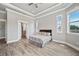 A bedroom with wood-look floors, offering space and serenity with natural lighting from big windows at 602 Swilley Rd, Plant City, FL 33567
