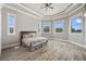 A spacious bedroom with wood-look floors and an abundance of natural light from large windows at 602 Swilley Rd, Plant City, FL 33567