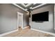 Bedroom featuring wood floors, TV, and open door to an ensuite bathroom at 602 Swilley Rd, Plant City, FL 33567