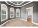 Gray bedroom featuring wood floors, large windows, and an open bathroom at 602 Swilley Rd, Plant City, FL 33567