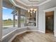 Bright dining area with large windows overlooking the outdoor kitchen and pool area at 602 Swilley Rd, Plant City, FL 33567