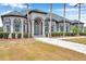 Charming home with a landscaped front yard, elegant columns, and arched windows that enhance its curb appeal at 602 Swilley Rd, Plant City, FL 33567