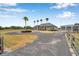 Attractive property featuring a circular driveway, mature trees, and a detached garage with ample space for vehicles and storage at 602 Swilley Rd, Plant City, FL 33567