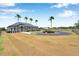 Spacious property showcasing a circular driveway, mature palm trees, and lush landscaping that adds to the home's charm at 602 Swilley Rd, Plant City, FL 33567