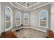 The home office features wood-look floors, three large windows, and stylish trim work at 602 Swilley Rd, Plant City, FL 33567
