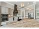 Well-lit kitchen with a large center island, stainless steel appliances, and gray cabinetry at 602 Swilley Rd, Plant City, FL 33567