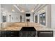 A close-up view of a kitchen island with a dark finish, stone countertop, and a view of the fireplace at 602 Swilley Rd, Plant City, FL 33567