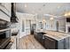 Modern kitchen featuring a center island, stainless steel appliances, and sleek black accents at 602 Swilley Rd, Plant City, FL 33567
