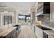 A gourmet kitchen boasts stone countertops, modern appliances, and a bay window for abundant natural light at 602 Swilley Rd, Plant City, FL 33567