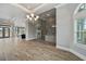Spacious living room with wood-look tile flooring, adjacent to kitchen at 602 Swilley Rd, Plant City, FL 33567
